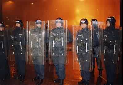 riot police face protesters